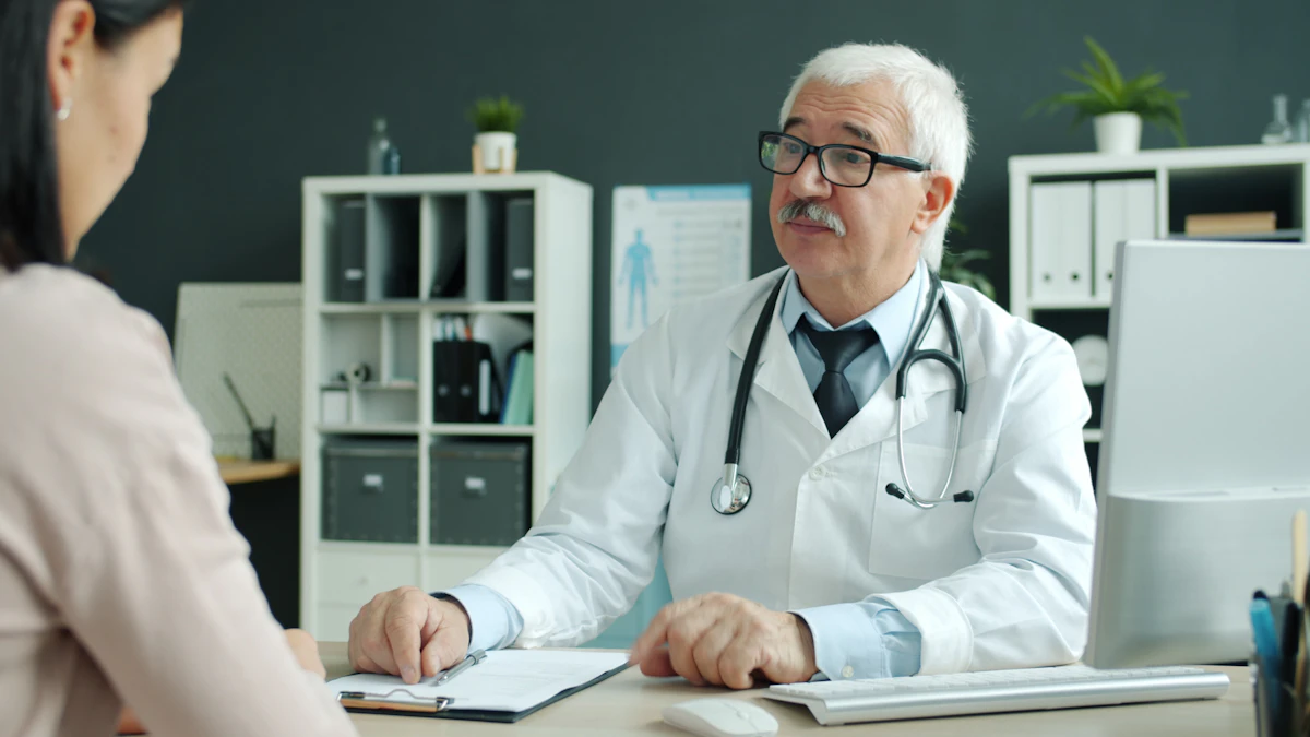 A doctor working at a clinic desk between patient appointments
